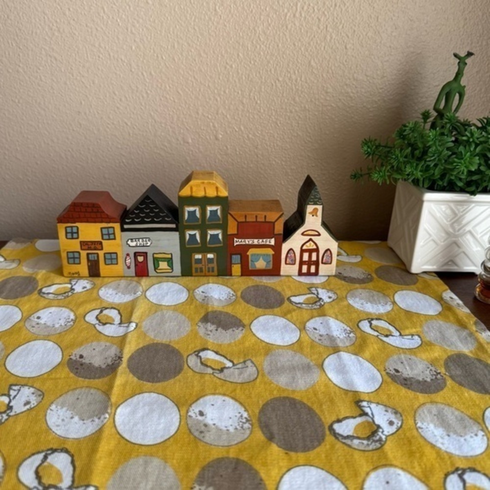 Vintage look carved wooden town shops block